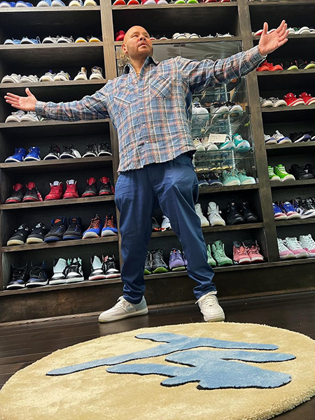 Large custom logo rug installed inside a sneaker store