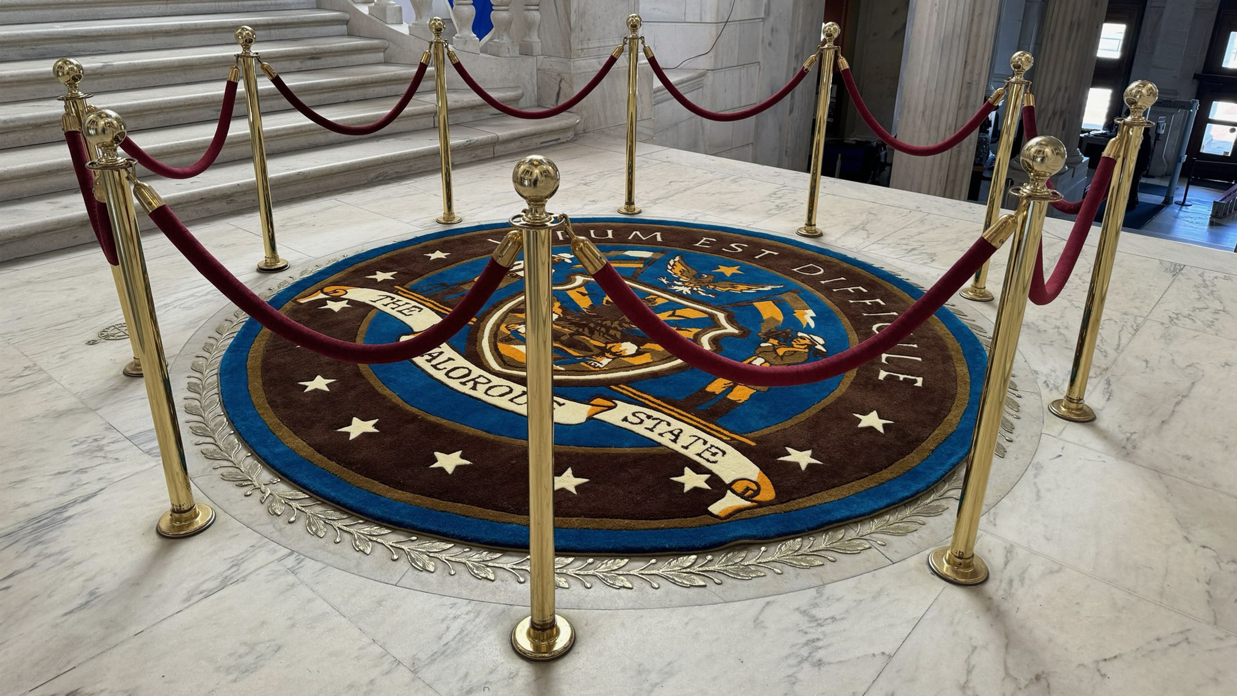 Large handmade custom state capitol seal rug created for the Ella McCay movie, showcasing institutional-scale custom rug craftsmanship