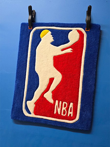 Custom basketball style logo rug hanging on a wall